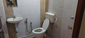 a bathroom with a toilet and a sink at Adithya Residency Guruvayur in Guruvāyūr