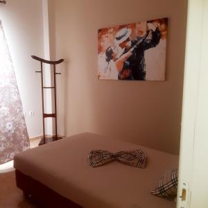 a bedroom with a bed with a bow tie on it at MARIA cozy apartments in Pigianos Kampos