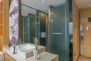 a bathroom with a sink and a mirror at Paco Hotel Shenzhen Luohu Port in Shenzhen