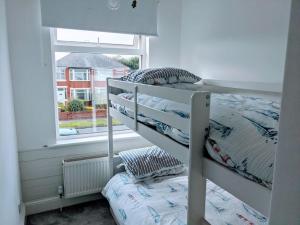 a bunk bed in a room with a window at No.12 In The Heart Of Blackpool in Blackpool