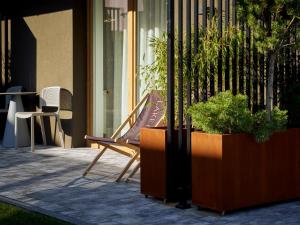 a bench sitting on a patio next to a table at Lake-Apart Apartamenty Mielno in Mielno +31 photos