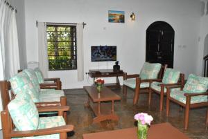 - un salon avec des chaises et une table dans l'établissement Sonnie House Diani, à Mombasa