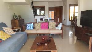 a living room with a couch and a coffee table at Riverside Villa at Siolim in Siolim