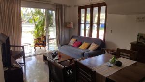 a living room with a couch and a table at Riverside Villa at Siolim in Siolim