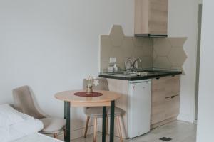 a small kitchen with a table and a sink at Apartmani Terase in Konjska Reka