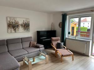 a living room with a couch and chairs and a window at Ubytování u Novotných in Vyšší Brod