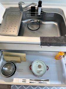 a drawer in a kitchen sink with utensils at Kith villa Kodomari 1 - Vacation STAY 14454 in Amami