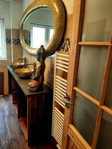 a bathroom with two sinks and a mirror at Haus Waldblick in Liebenwalde