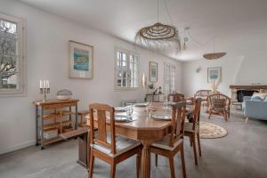 uma sala de jantar e sala de estar com mesa e cadeiras em Echappee familiale pres de la plage a Sarzeau em Sarzeau