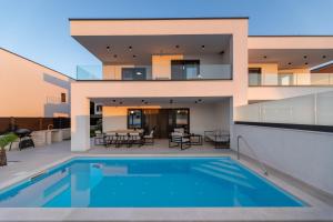 an exterior view of a house with a swimming pool at Villa Aria in Klimno
