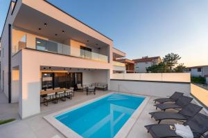 an image of a house with a swimming pool at Villa Aria in Klimno +42 photos