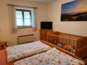 a small bedroom with a crib and a crib at Schmidtler`s Nest in Warngau