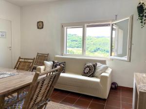 a living room with a couch and a table at Villetta con Oliveto CFG in Prizzi