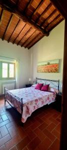 una camera da letto con un letto con cuscini rossi di Tuscan home in the heart of Chianti a Greve in Chianti