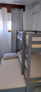 a bunk bed in a small room with a ladder at Maison de la plage in Valras-Plage +7 photos