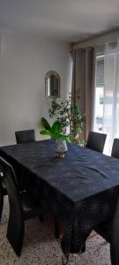 a dining room table with a blue table cloth on it at Maison de la plage in Valras-Plage