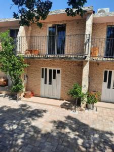 a brick building with white doors and a balcony at Amanda C in Starigrad