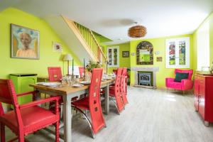 a dining room with a table and red chairs at Fell End in Brampton