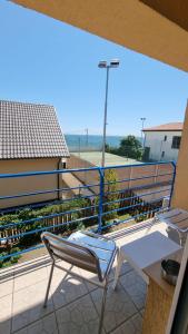 a chair on a balcony with a view of the ocean at Harmony Villa in Costinesti