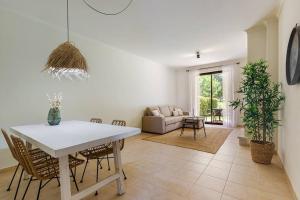 a living room with a white table and chairs at Comfort relax w pool near beach in Alvor