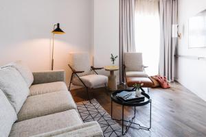 a living room with a couch and chairs and a table at The Alida, Savannah, a Tribute Portfolio Hotel in Savannah