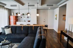 a living room and dining room with a couch and dining table at The Alida, Savannah, a Tribute Portfolio Hotel in Savannah