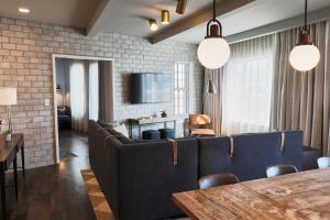a dining room with blue chairs and a table at The Alida, Savannah, a Tribute Portfolio Hotel in Savannah