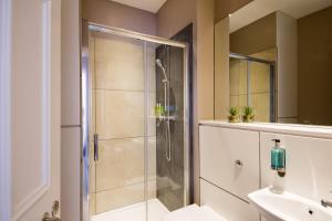 a bathroom with a shower and a sink at The Spires Serviced Apartments Edinburgh in Edinburgh