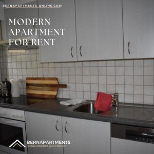 a kitchen with a sink and a counter top at City-Home: 6P-80qm 6km HB Bern in Zollikofen