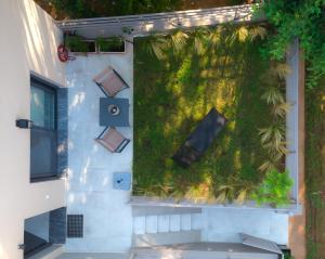 a vertical garden on the side of a building at Osiris - cozy sea walk lodge with private garden in Nea Makri