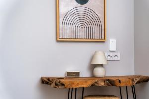a console table in a room with a picture on the wall at Selene Luxury Rooms in Armenistis