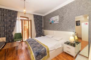 a bedroom with a bed and a desk and a chair at Taksim full House in Istanbul