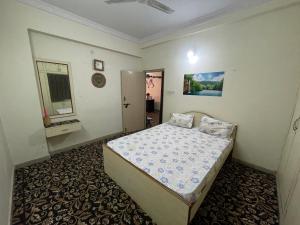 a bedroom with a bed and a mirror in it at A to Z Guest House in Hyderabad