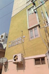 a building with a sign on the side of it at A to Z Guest House in Hyderabad