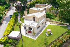 an aerial view of a house with a yard at Artemisia Villa, Sani Luxury Villas collection in Sani Beach