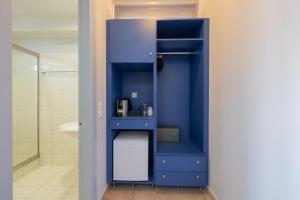 a blue cabinet in a bathroom with a shower at Pelagos Apartments in Skala Kefalonias