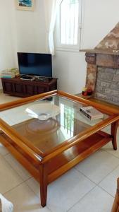 a coffee table with a glass top in a room at Mirto’s House 