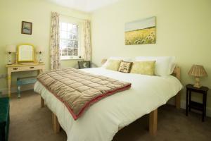 En eller flere senge i et værelse på Walltown Farm Cottage