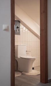 a bathroom with a white tub in a room at Osiris - cozy sea walk lodge with private garden in Nea Makri