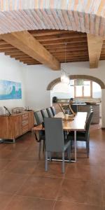 a dining room with a wooden table and chairs at Villa Emma-Toscanaparadiso in Pomaia