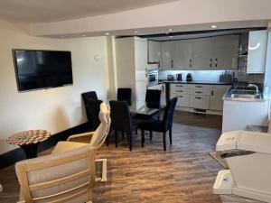 cocina y comedor con mesa y sillas en SmithStayz Apartments Epping en Epping