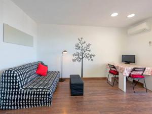 a living room with a couch and a table at Stay Barcelona - Castelldefels in Castelldefels
