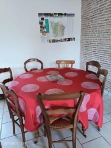 a red table with chairs and a red table cloth on it at La Chaumière de Mauvrain in La Celle-sur-Nièvre +19 photos