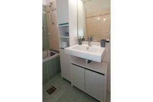 a bathroom with a white sink and a shower at Bougainvillea Apartment Spacious Family Home in Zakynthos Town in Zakynthos +32 photos
