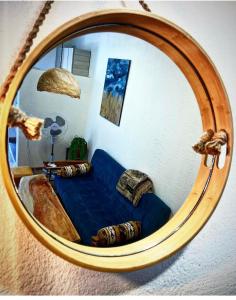 a mirror reflecting a living room with a blue couch at Зелёный двор in K'obulet'i
