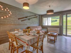 a living room with a table and a couch at Appartement Gourette, 2 pièces, 6 personnes - FR-1-400-51 in Gourette