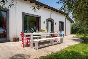 une table et des chaises devant une maison dans l'établissement Villa Mascali Nature & Relax - Affitti Brevi Italia, à Nunziata