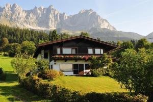 a house on a field with mountains in the background at Haus Pöll in Prama