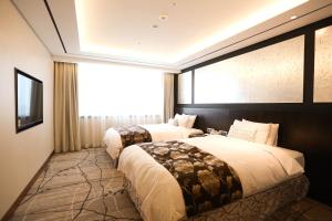 Postel nebo postele na pokoji v ubytování Lotte Hotel Ulsan