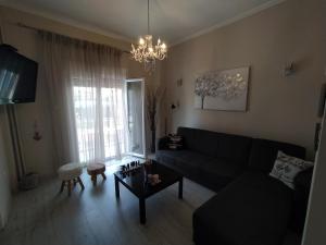 a living room with a couch and a table at Anthi's house in Preveza